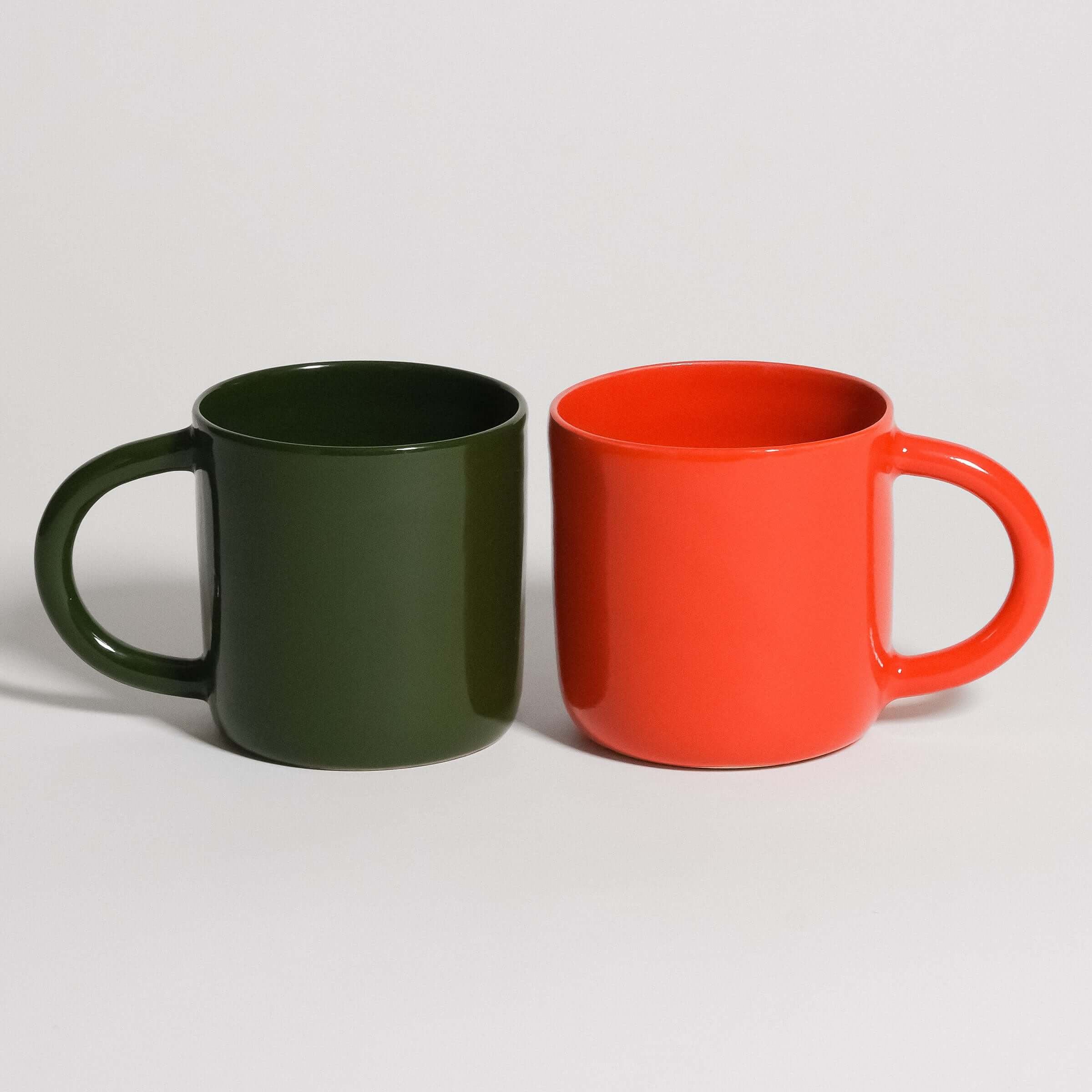 Cup Sets featuring a green mug and an orange mug side by side on a white background.