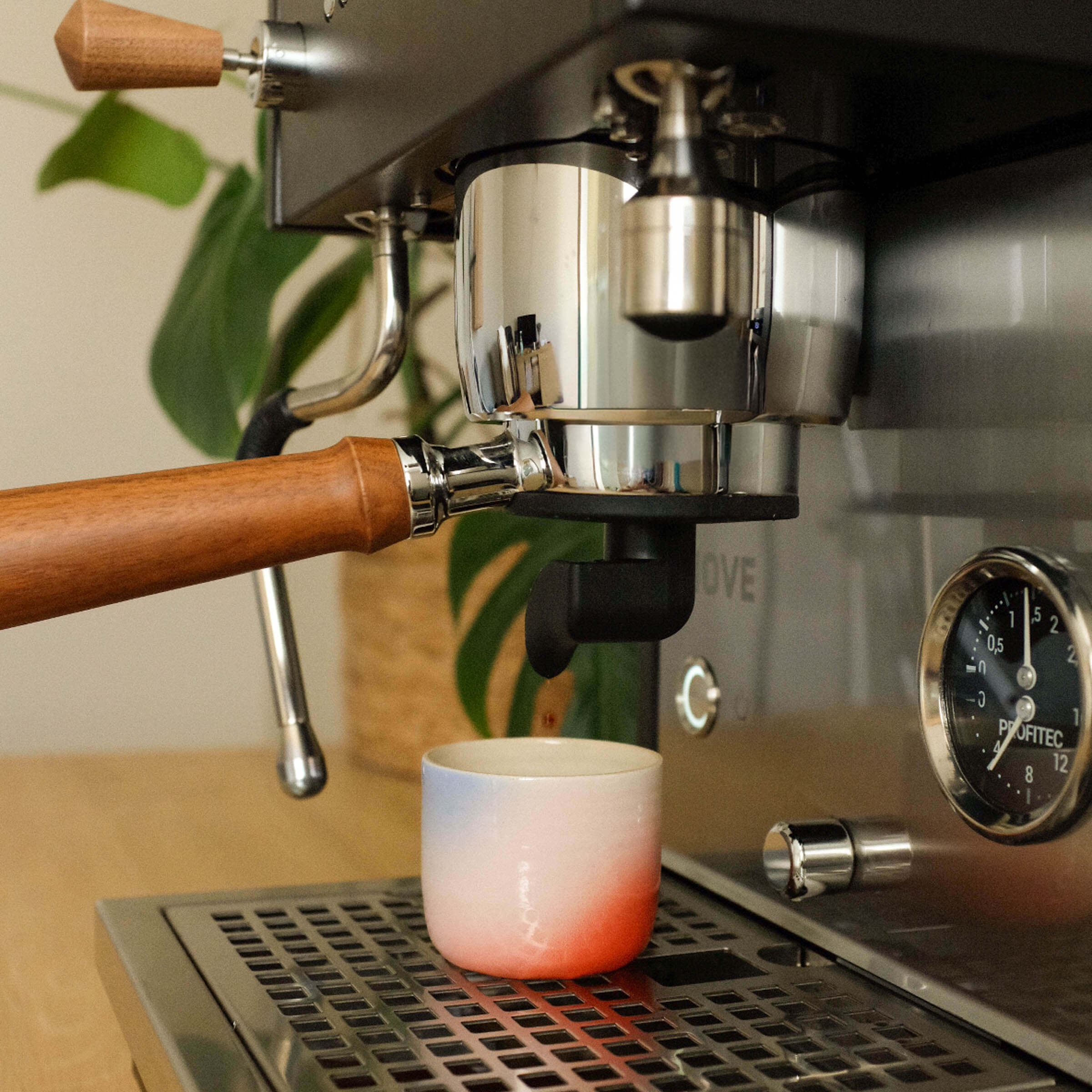 Handmade Espresso Cups being used with an espresso machine for the perfect coffee experience.