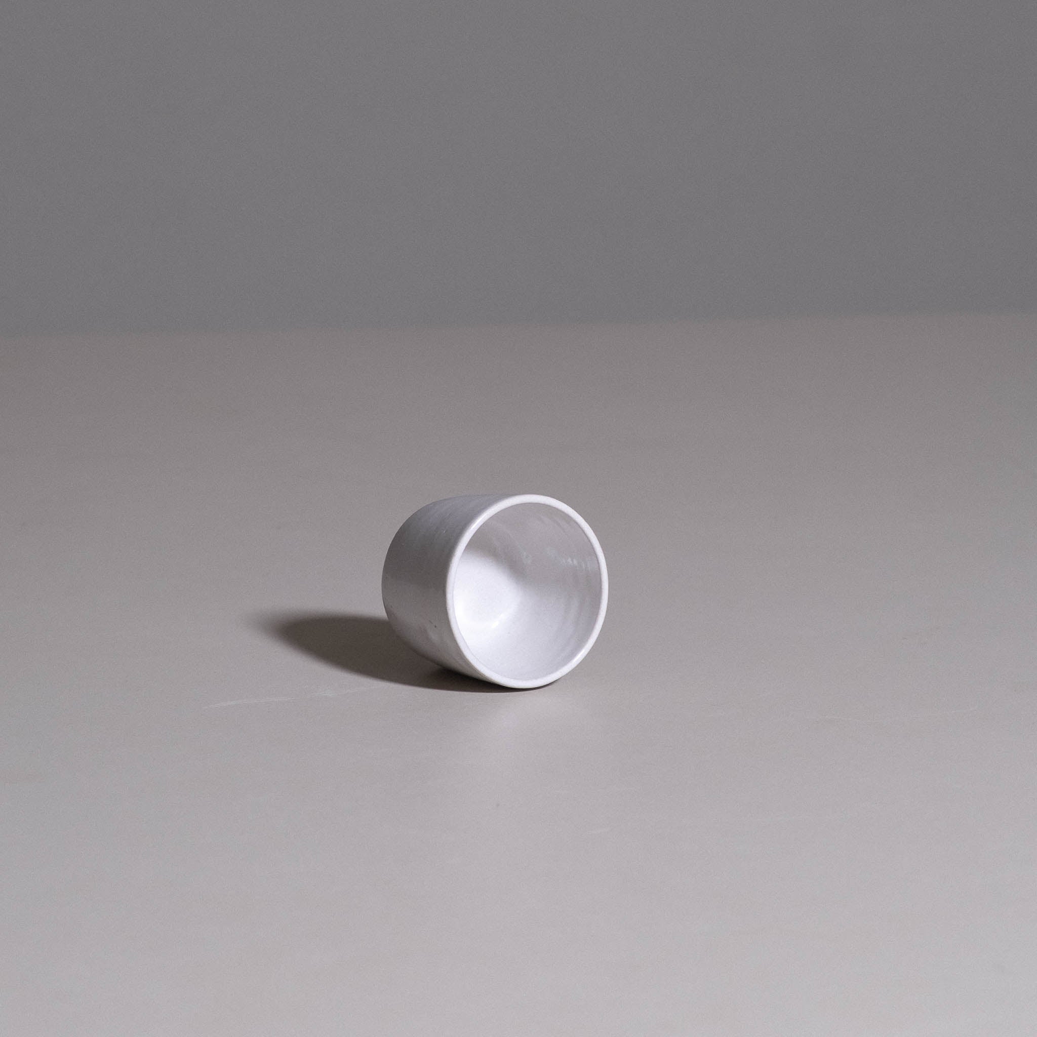 Espresso Cup aus handgemachter Keramik in Weiß mit klarer konischer Silhouette.
