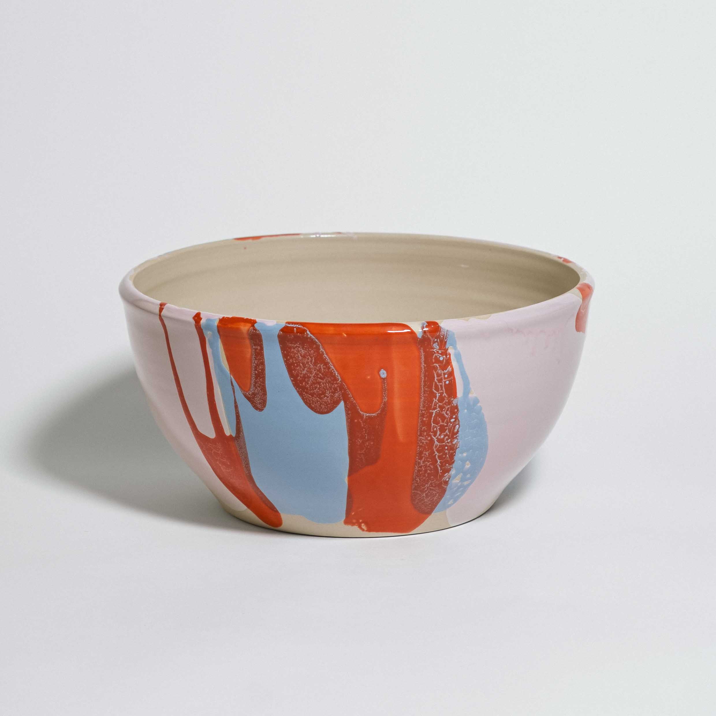 Handmade one-of-a-kind ceramic serving bowl, cream interior with red and blue glaze splashes, by Viola Beuscher