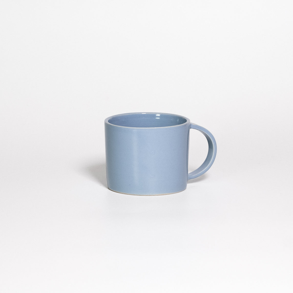 Coffee Mug Iceblue, low wide handled stoneware mug with glossy ice blue glaze, handle to the right