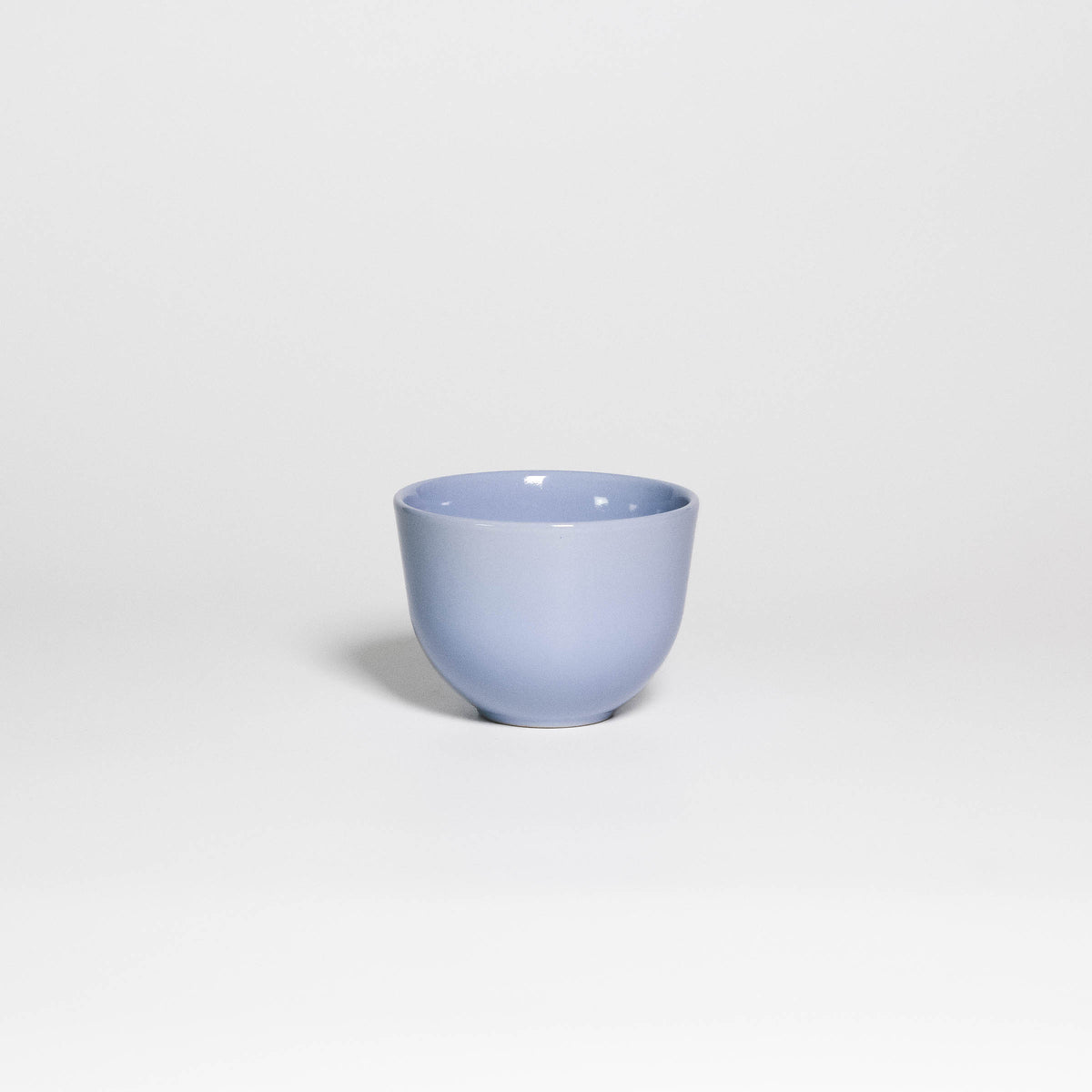 Coffee Cup Yun Iceblue, handleless stoneware cup with glossy ice blue glaze, front view