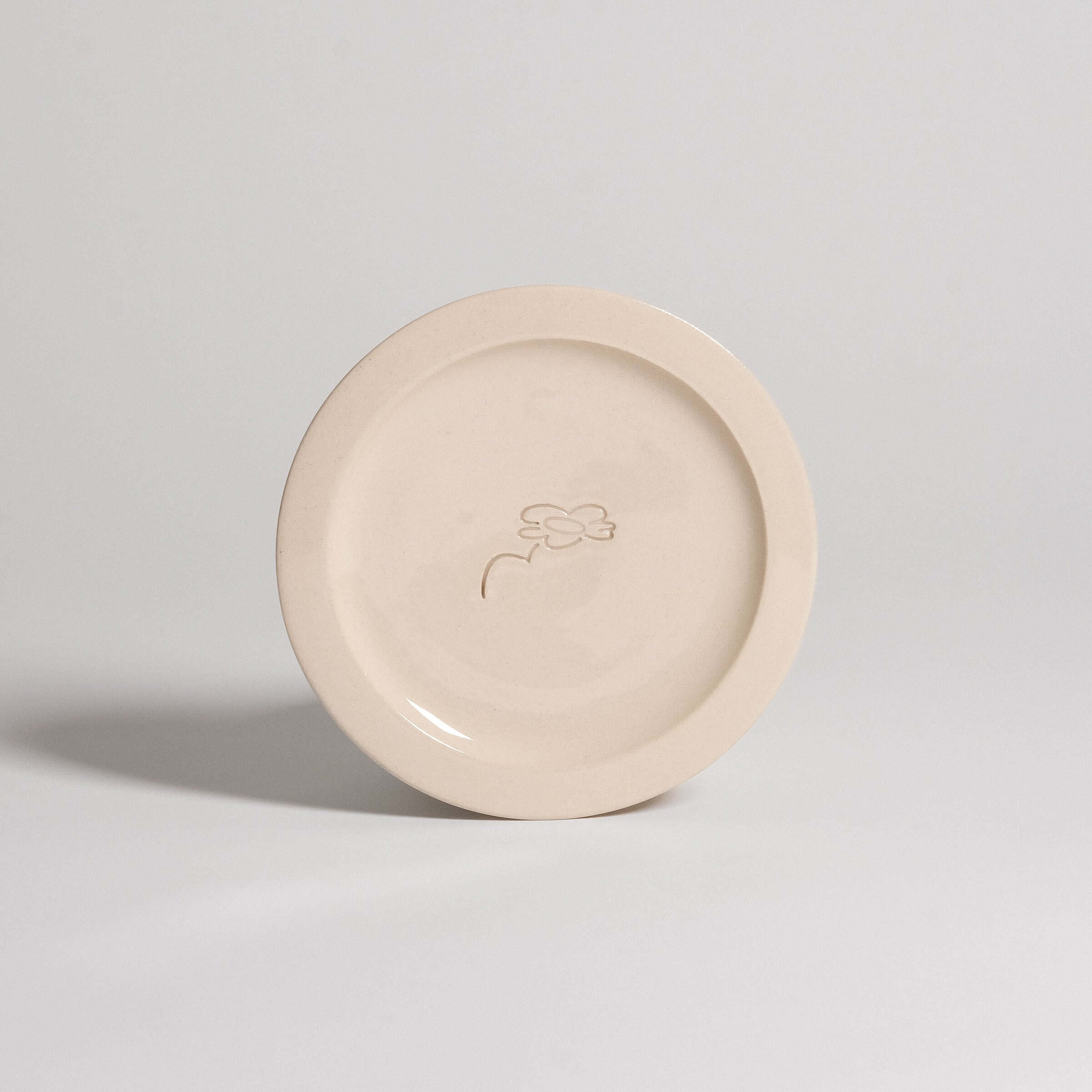 Handcrafted Neo Creme bistro plate, stoneware ceramic with embossed logo, dishwasher and oven safe.