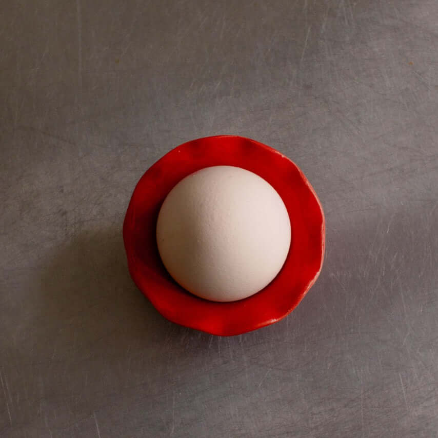 Handmade Stoneware Egg Cup – Egg Cup Red with a white egg in a red ceramic holder