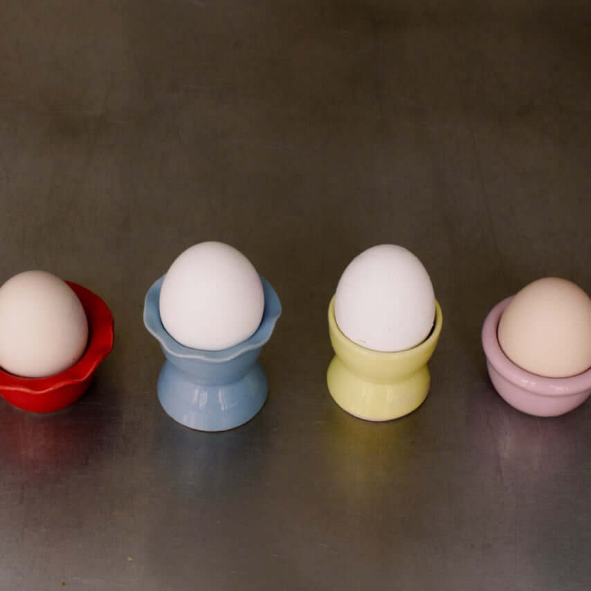Handmade Stoneware Egg Cup – Egg Cup Neon Yellow in vibrant colors including red, blue, yellow, and pink.
