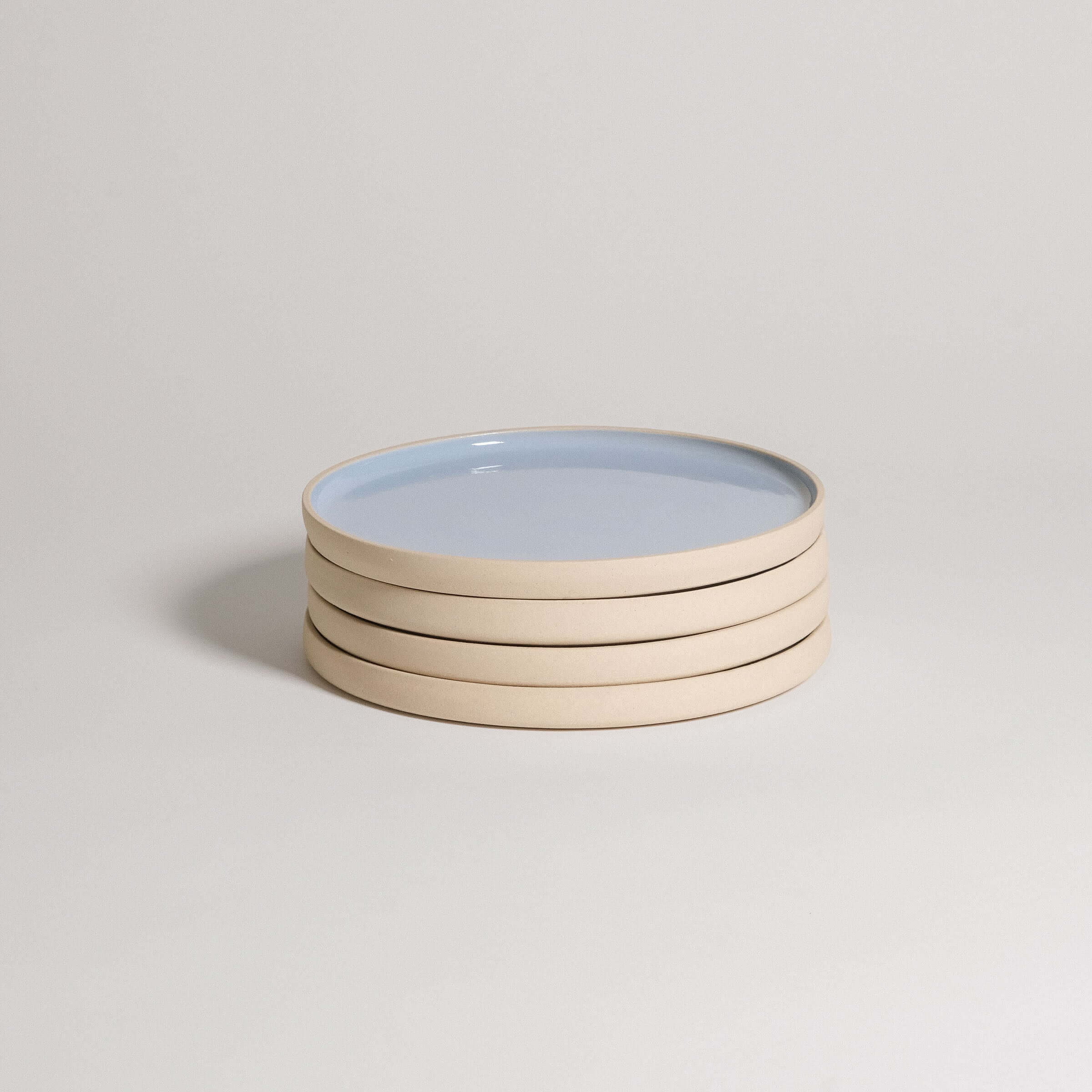 Mix & Match - Plate Bundle featuring stacked light blue and beige plates for versatile dining options.