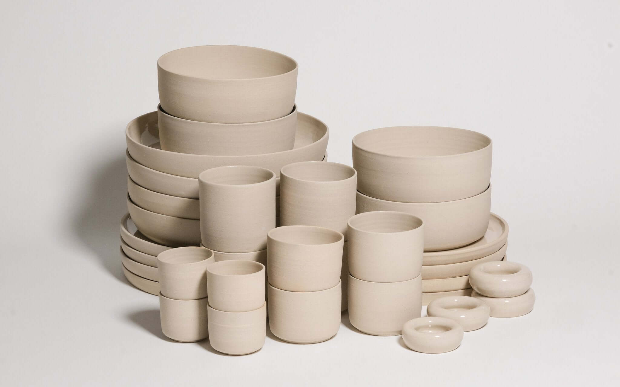 Mix & Match - Tableware Bundle featuring a variety of neutral-toned bowls and cups arranged artistically.