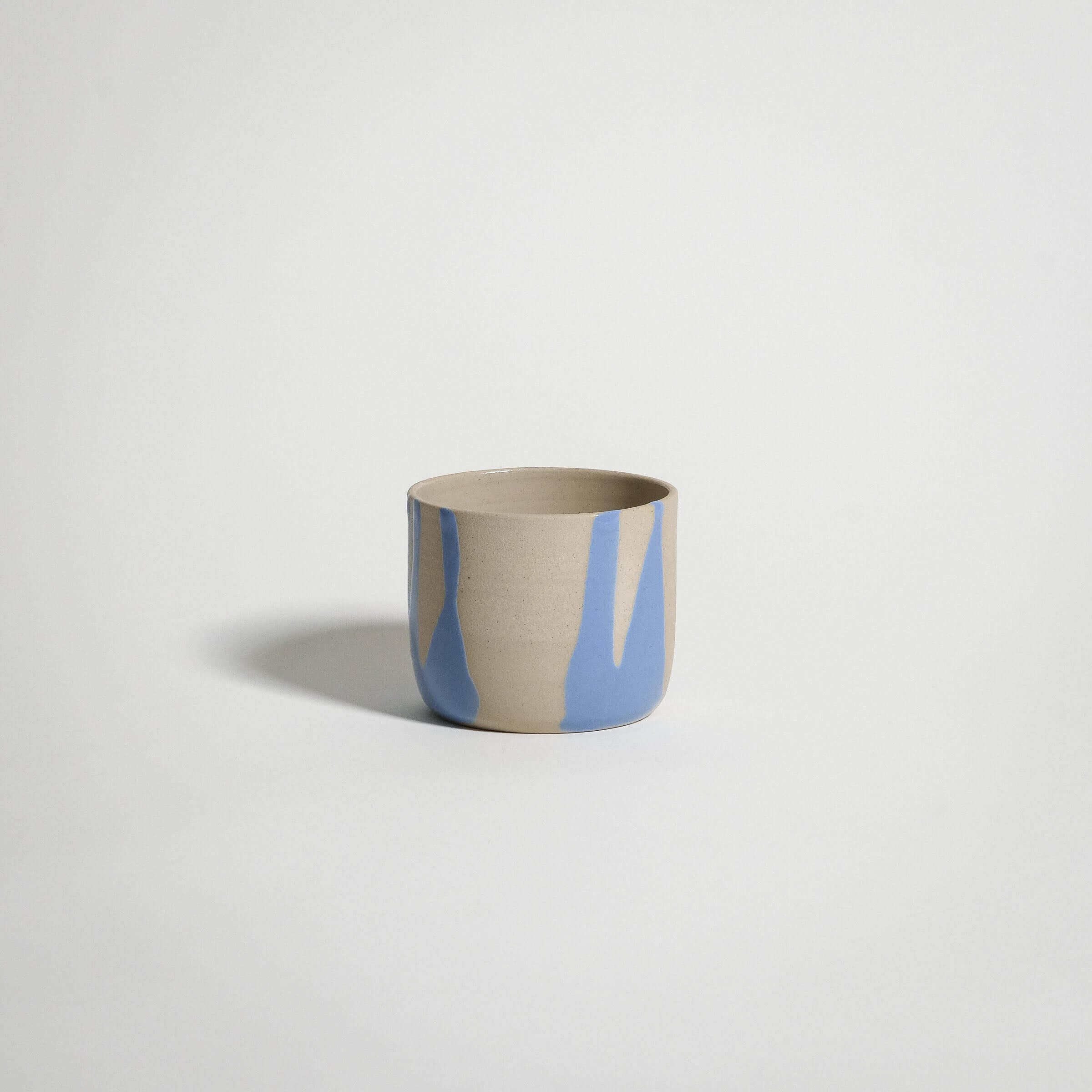 Handcrafted Splash Blue coffee cup, wheel-thrown from grey stoneware clay, perfect for warm beverages.