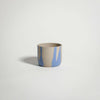 Handcrafted blue stoneware coffee cup with glossy glaze, perfect for tea or warm beverages.