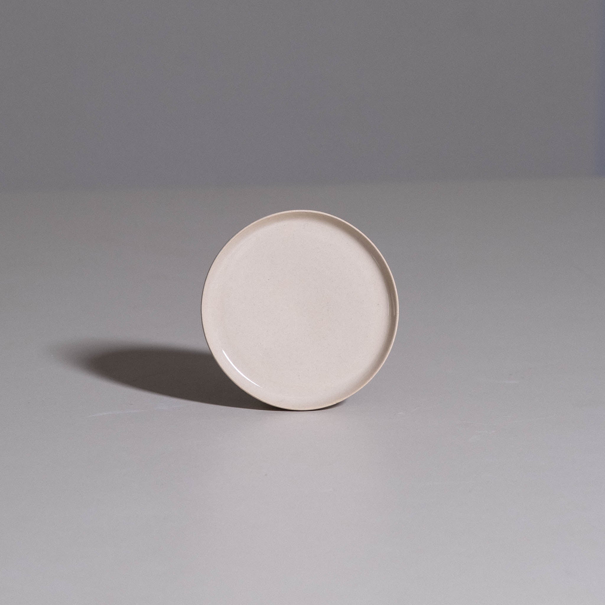 Saucer – Creme made from handmade ceramic showing its smooth creme glazed surface.