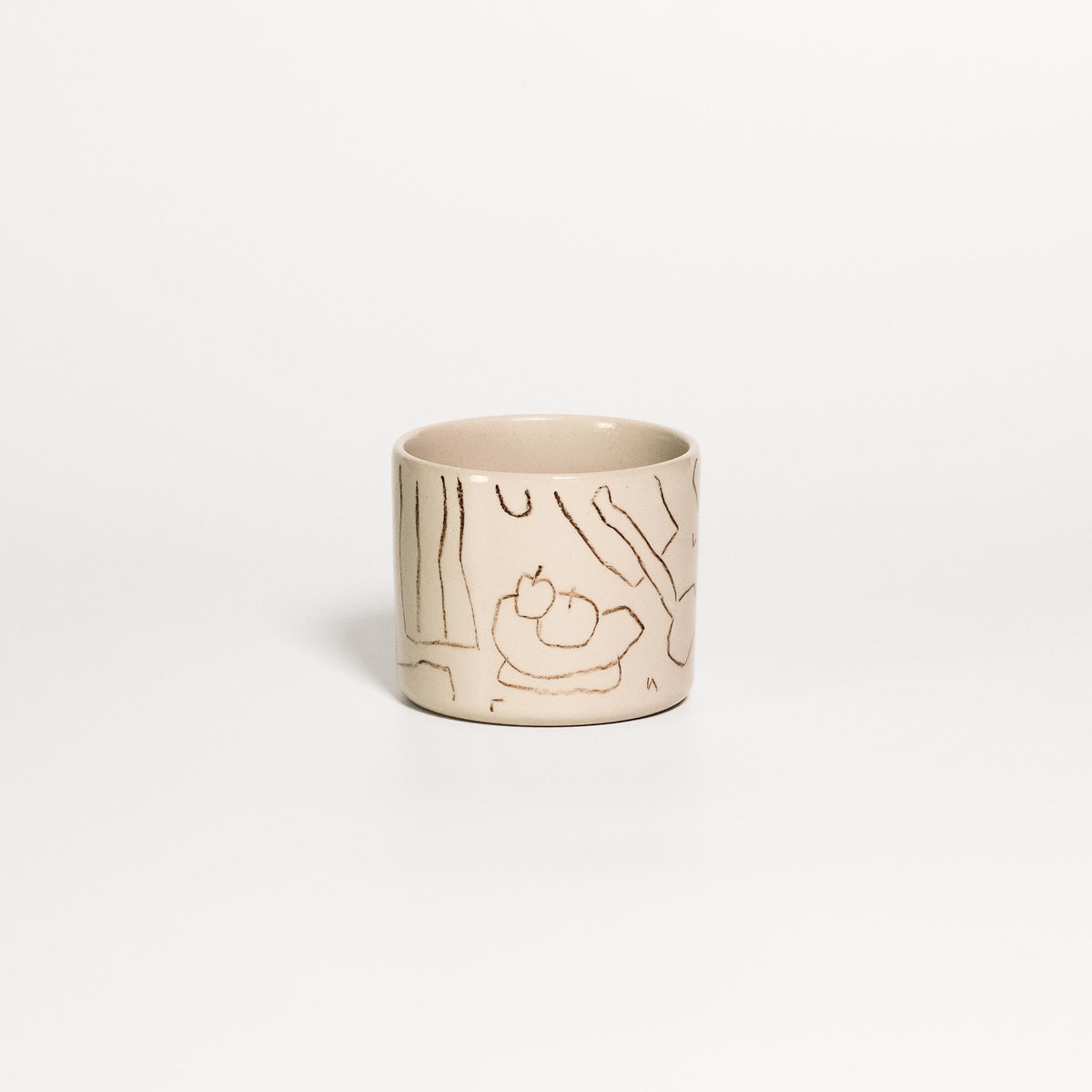 Creme stoneware coffee cup with a fine brown line drawing of a fruit bowl and table scene by Steffi Bauer under clear gloss glaze