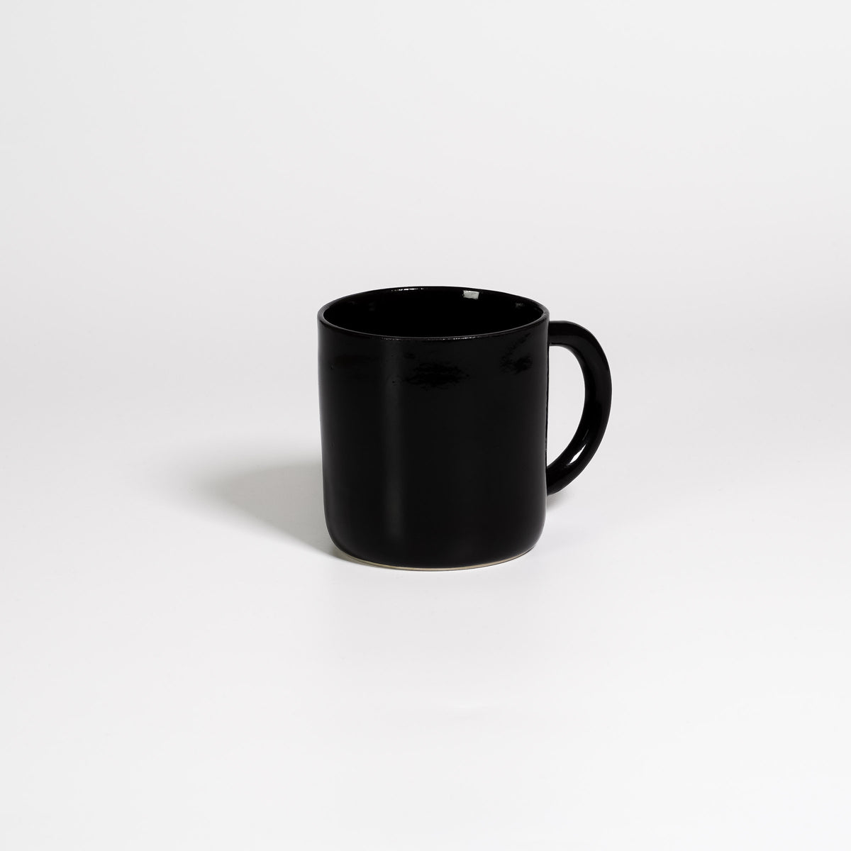 Coffee Mug Large Black, handled stoneware mug with glossy black glaze, handle turned away