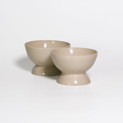 Two Dessert Dishes Creme side by side, footed stoneware dishes with transparent glossy glaze
