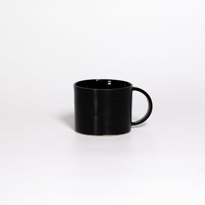 Coffee Mug Black, low wide handled stoneware mug with glossy black glaze, handle to the right