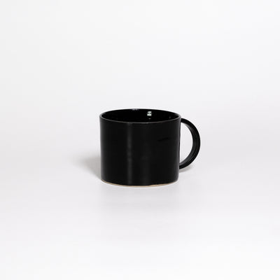 Coffee Mug Black, low wide handled stoneware mug with glossy black glaze, handle turned away
