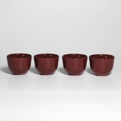 Set of 4 Coffee Cups Yun Rouge Noir, four handleless stoneware cups in a row, glossy rouge noir glaze