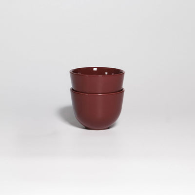 Two Coffee Cups Yun Rouge Noir stacked, handleless stoneware cups with glossy rouge noir glaze