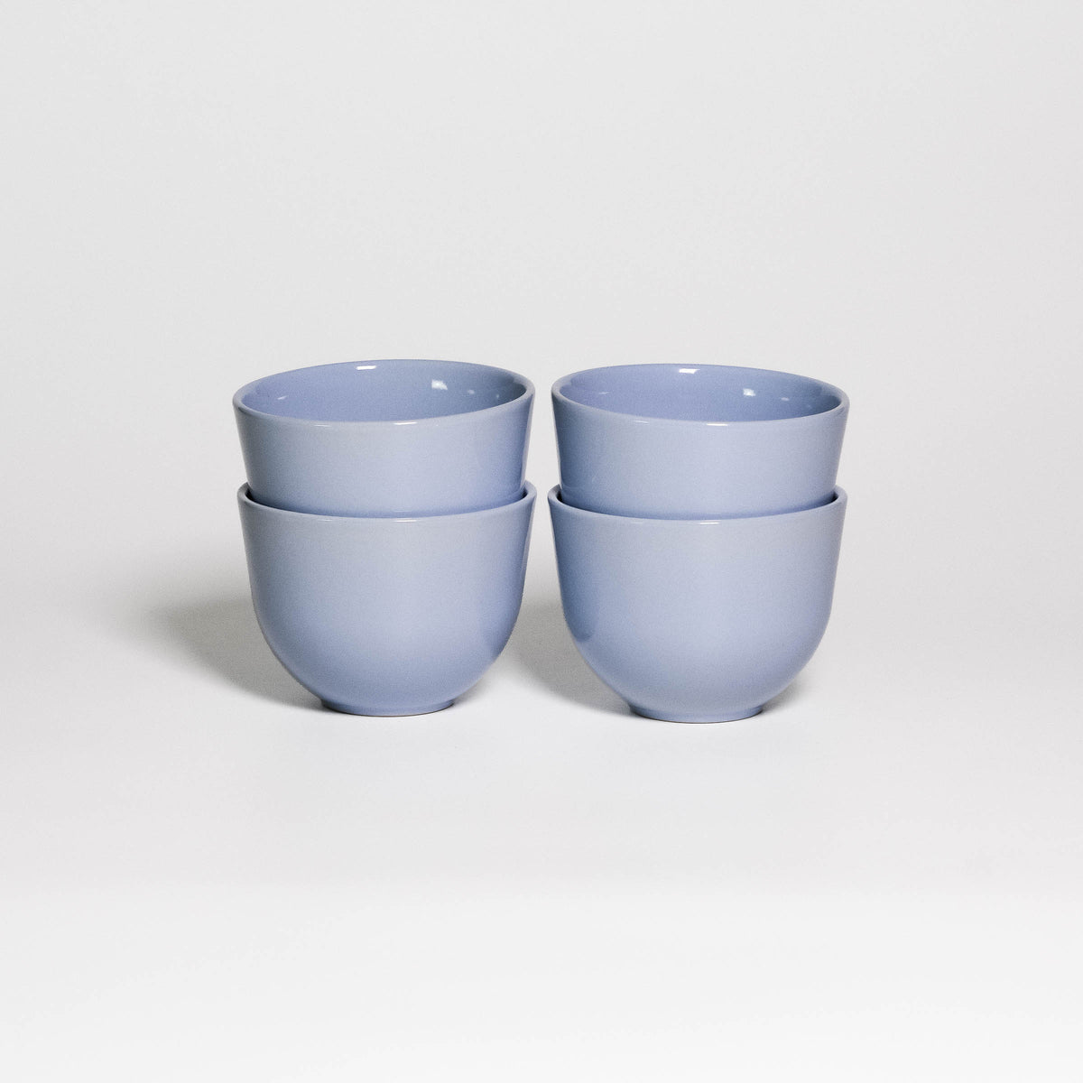 Set of 4 Coffee Cups Yun Iceblue, four handleless stoneware cups stacked in two pairs, glossy ice blue glaze