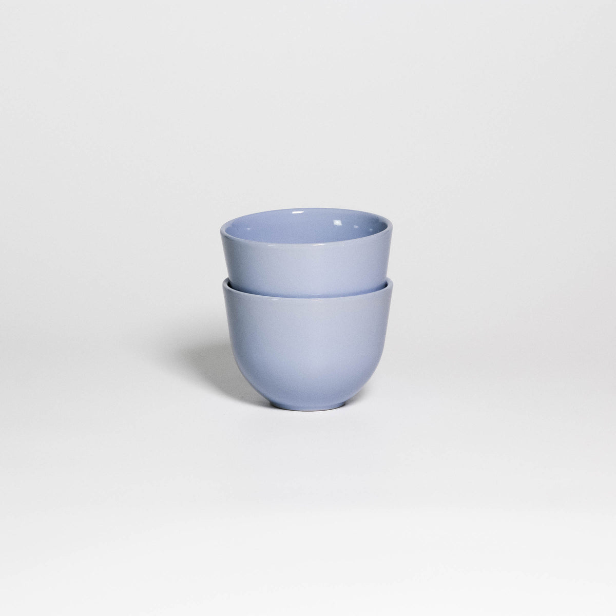 Two Coffee Cups Yun Iceblue stacked, handleless stoneware cups with glossy ice blue glaze