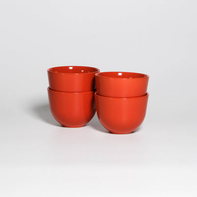 Set of 4 Coffee Cups Yun Orange, four handleless stoneware cups stacked in two pairs, glossy orange glaze, second view