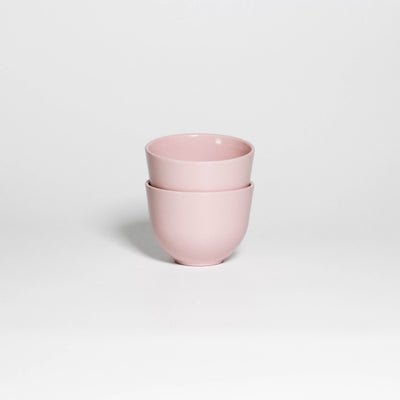 Two Coffee Cups Yun Pink stacked, handleless stoneware cups with glossy soft pink glaze, second view