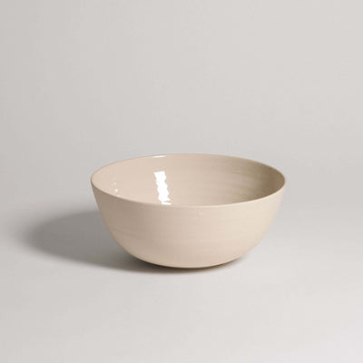 Ramen bowl in creme color, made of grey stoneware with glossy glaze inside and raw finish outside.