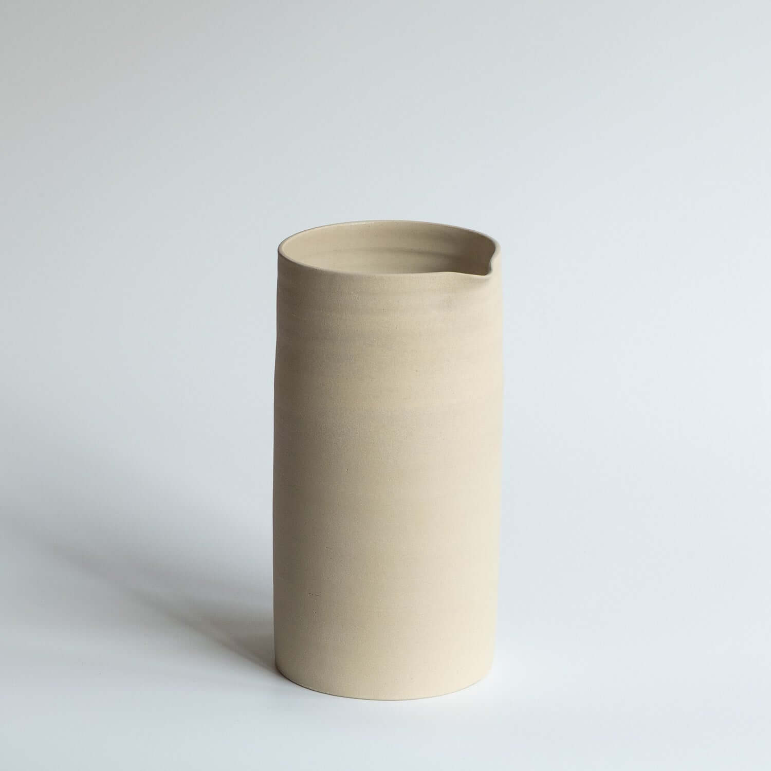 Handcrafted Carafe – Creme with a smooth glaze, perfect for serving beverages in a unique design.