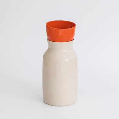 Handmade Carafe – Creme showcasing a unique design with an orange rim, ideal for elegant table settings.