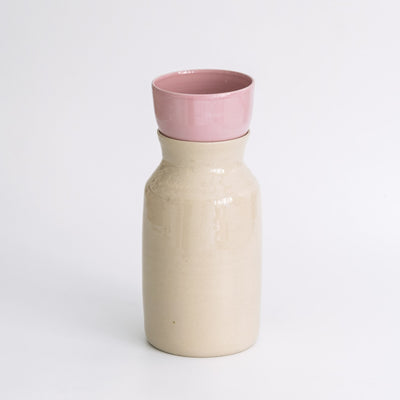 Handmade Carafe – Creme showcasing a high-quality stoneware design with a warm creme glaze and a pink top.