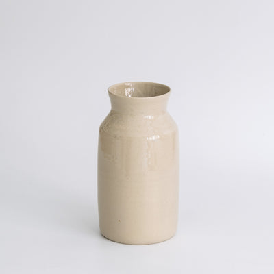 Handmade Carafe – Creme showcasing a tapered stoneware silhouette with a warm creme glaze.