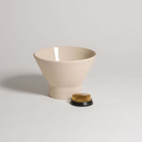 Ikebana Vase – Kenzan Set featuring a beige vase and a kenzan holder with metal spikes for flower arrangement.