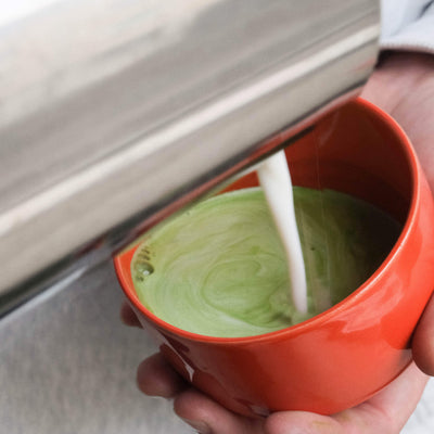 Matcha Set – Classic - Organic Ceremonial Matcha Supreme being prepared with milk in a glossy red matcha cup.