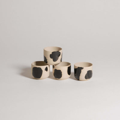 Mix & Match - Cup & Mug Bundle featuring four unique ceramic cups with black and beige designs.