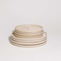 Mix & Match - Plate Bundle featuring a stack of elegant beige dinner plates.