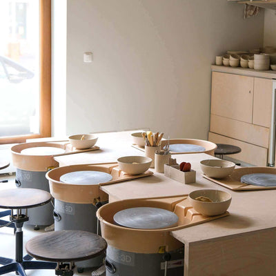 Gift Making Class setup with pottery wheels and materials for creative sessions.