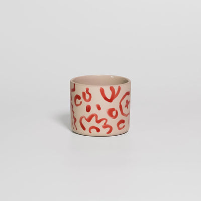 Video of the hand-painted red coffee cup by Viola Beuscher x Steffi Bauer, turning to show the illustration all around