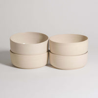 Set of 4 Nomi Creme breakfast bowls made from grey stoneware with a glossy interior and raw exterior.