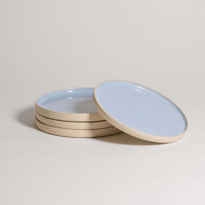 Set of 4 handcrafted stoneware breakfast plates in Iceblue glaze, showcasing unique character and food-safe design.