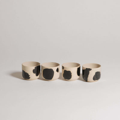 Set of 4 Nomi Pepe espresso cups in grey stoneware with glossy black hand-painted accents.