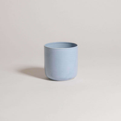 Handcrafted iceblue tea cup from the Nomi collection, made of durable stoneware ceramic, showcasing unique design.