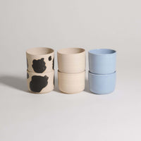 Mix & Match - Cup & Mug Bundle featuring stacked cups in black and blue glazes for personalized styles.