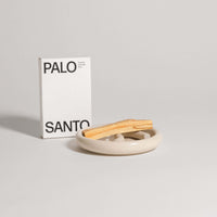 Palo Santo dish with stick and packaging, showcasing grey stoneware clay and glossy glaze, sustainably sourced from Peru.